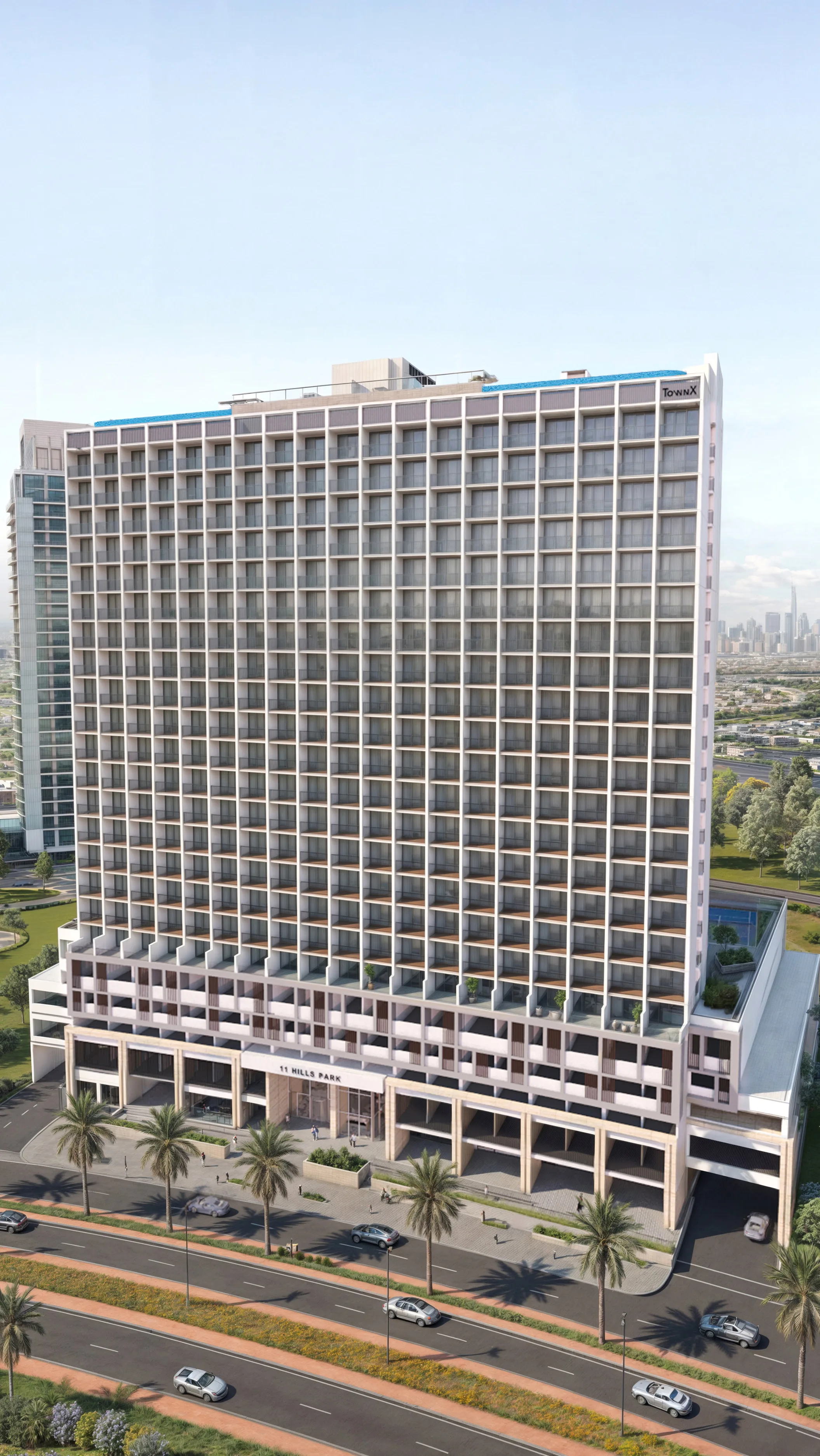 Башня 11 Hills Park сверху: вход, пальмы вдоль улицы и город вдали