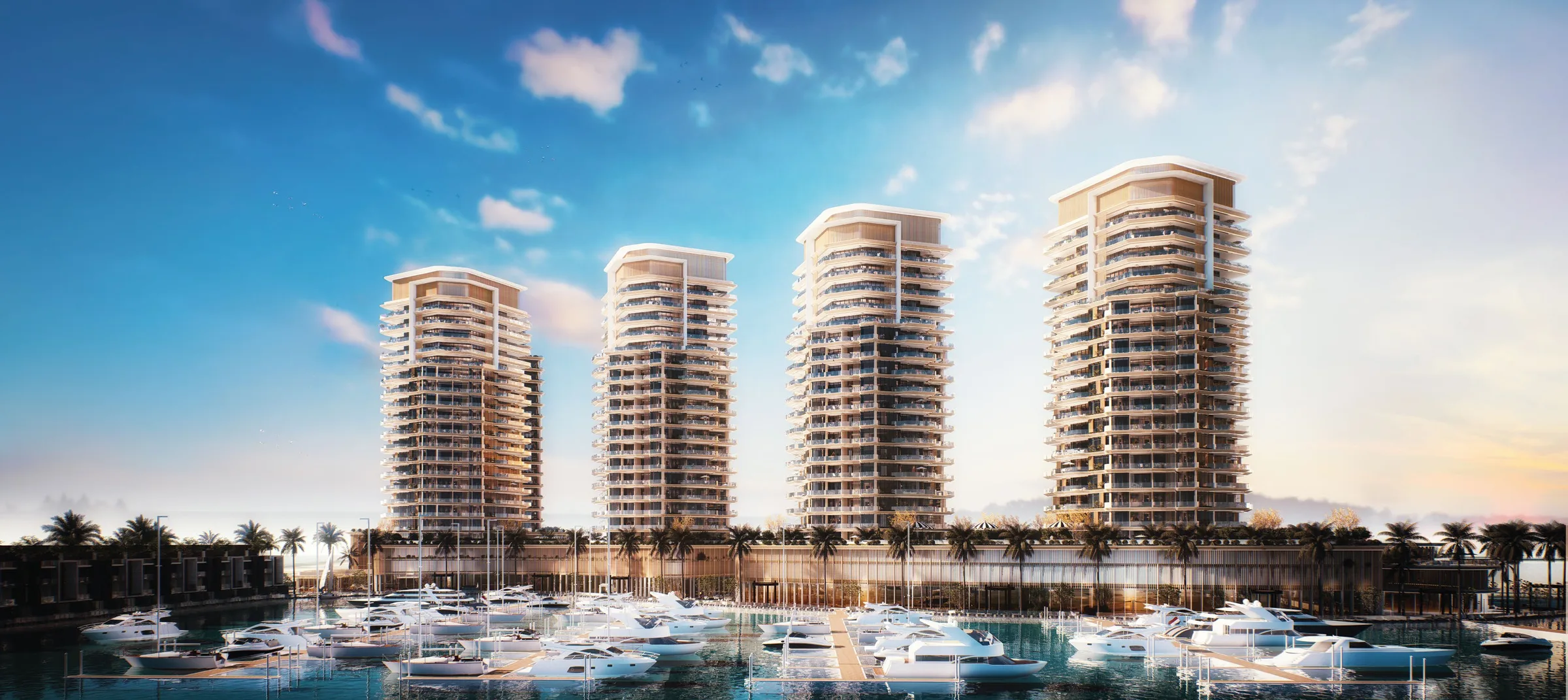 Четыре башни Al Hamra Waterfront над яхтами марины