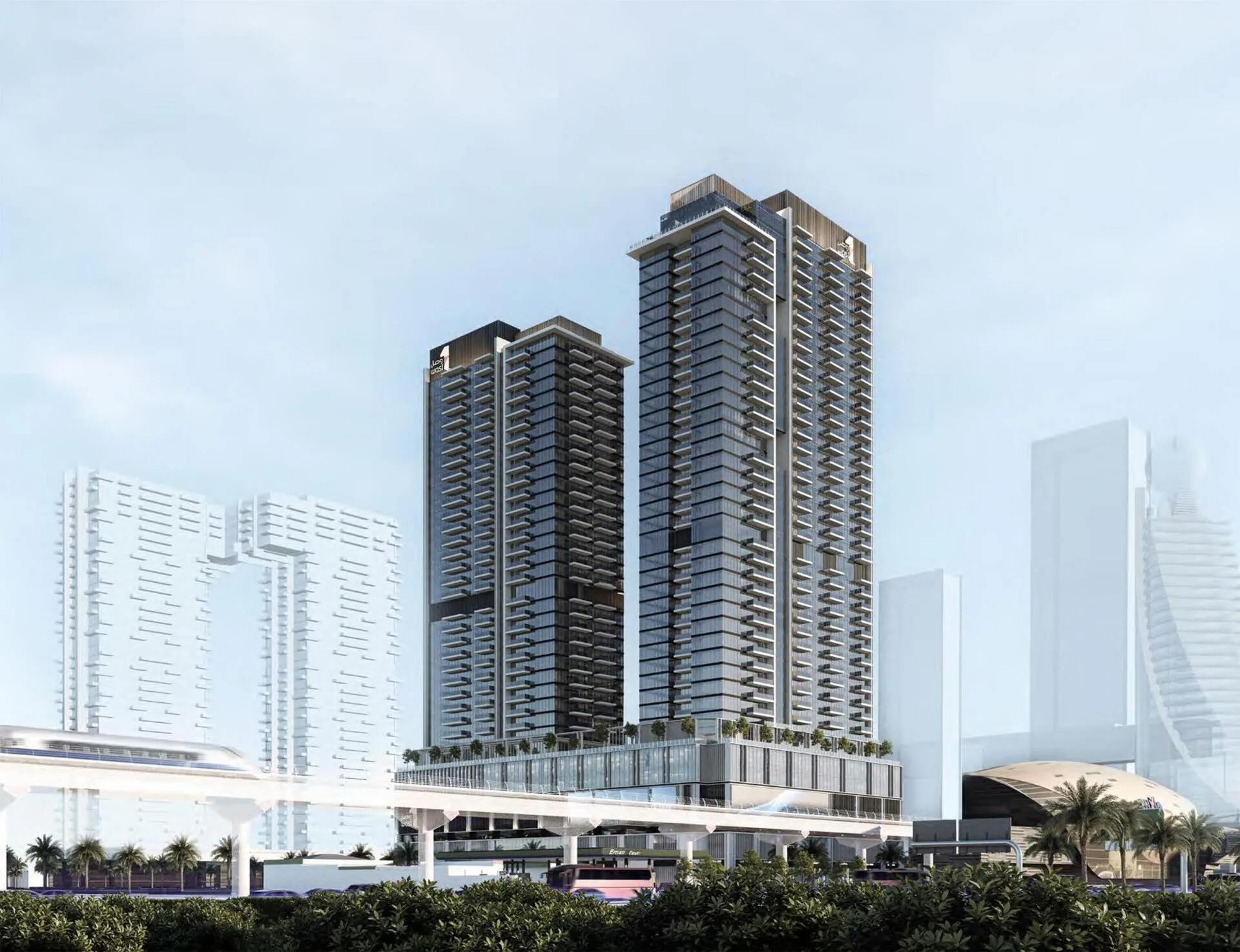 Две башни Avenue Park Towers днём над зеленью и эстакадой метро