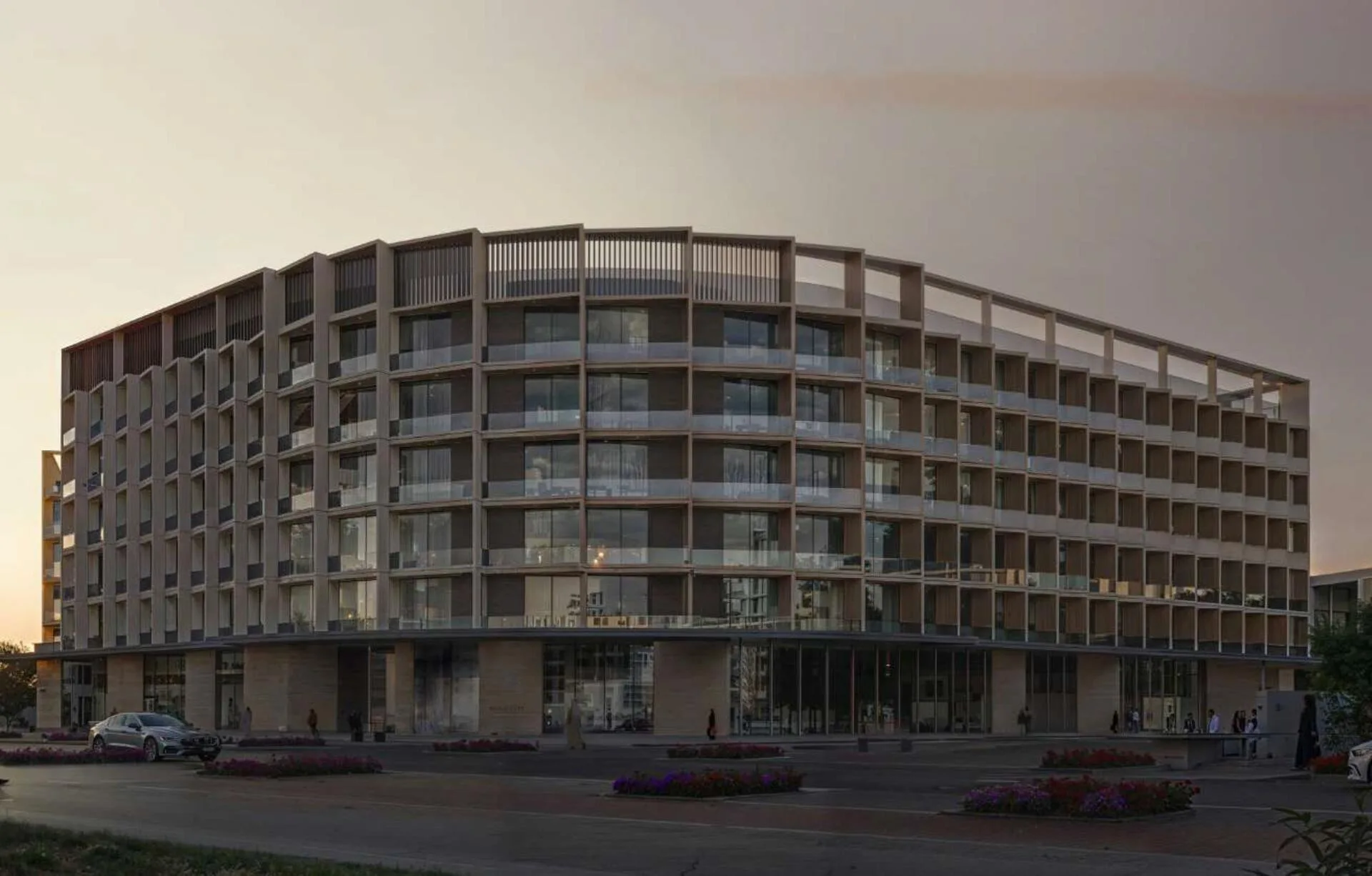 Изогнутый фасад Binghatti Hillcrest на закате