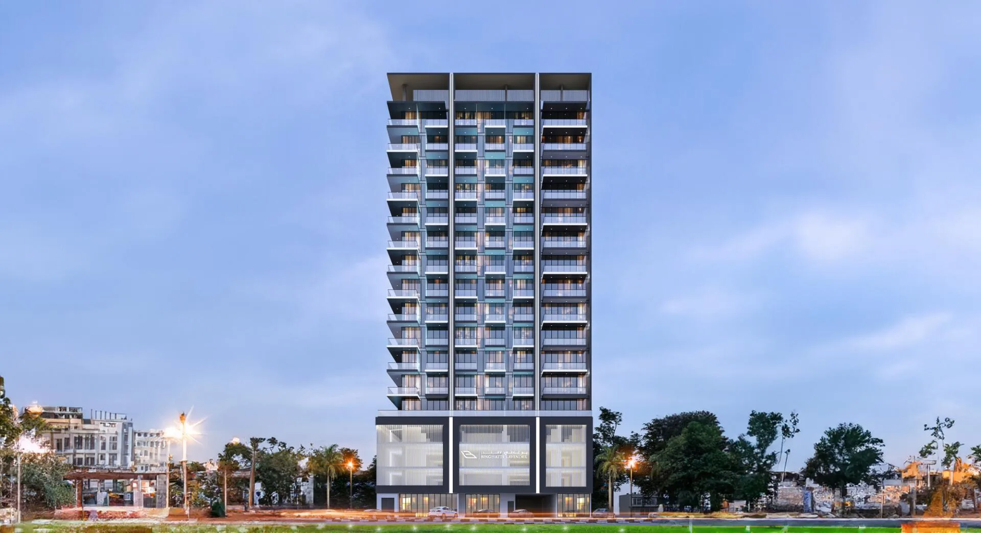 Binghatti Lavender среди деревьев Jumeirah Village Circle в сумерках