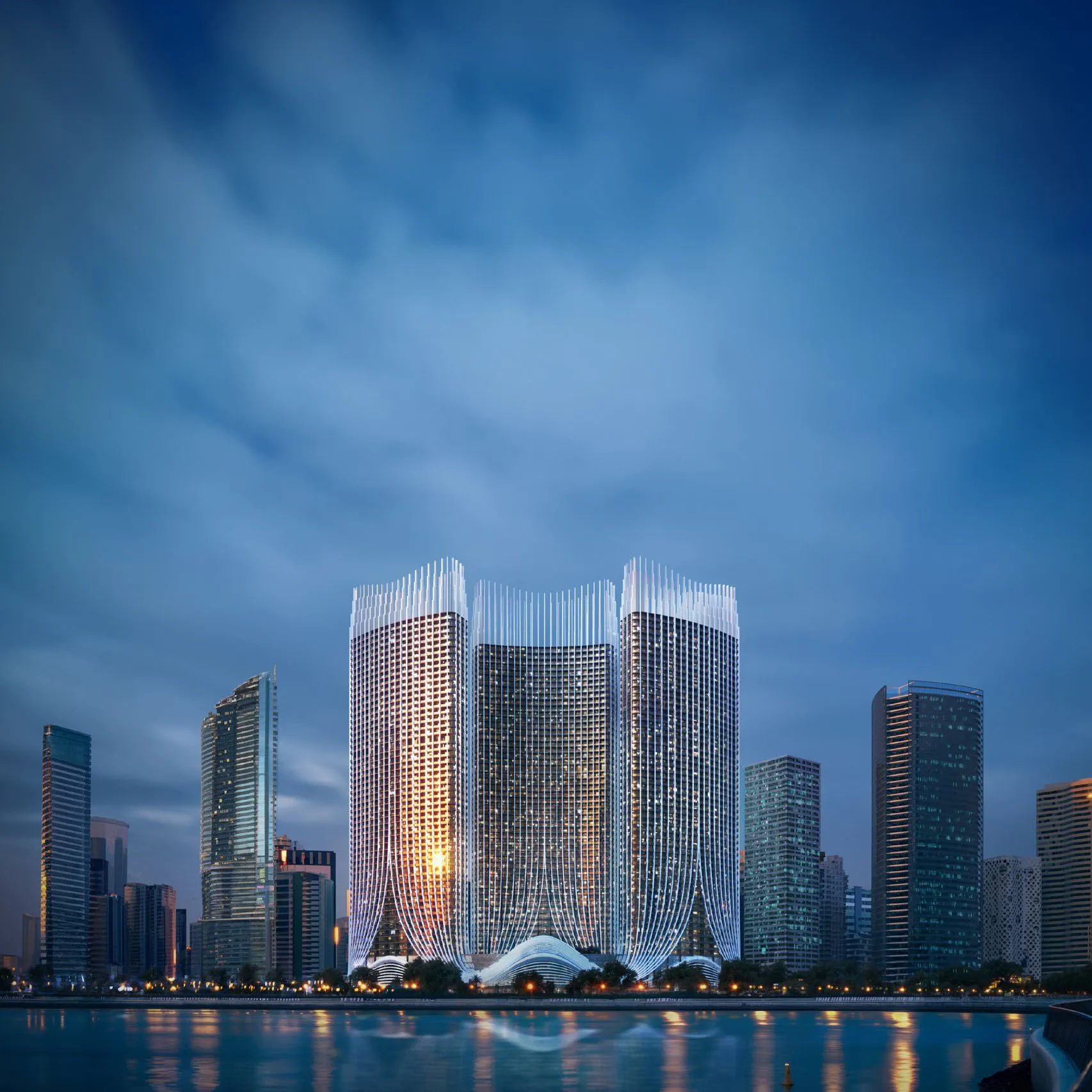 Три башни Binghatti Skyrise над водой вечером