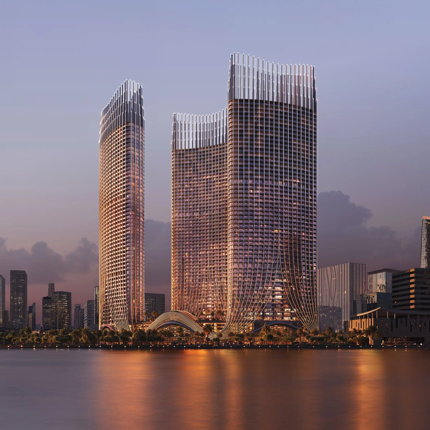 Башни Binghatti Skyrise над водой в вечерних сумерках