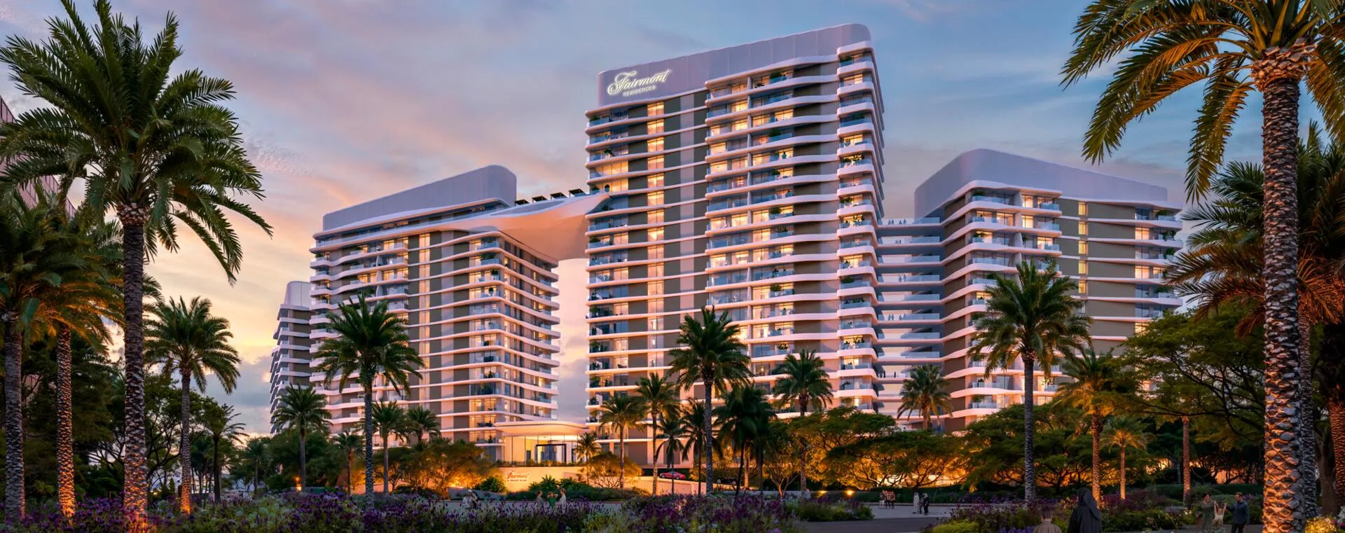 Башни Fairmont Residences вечером среди пальм
