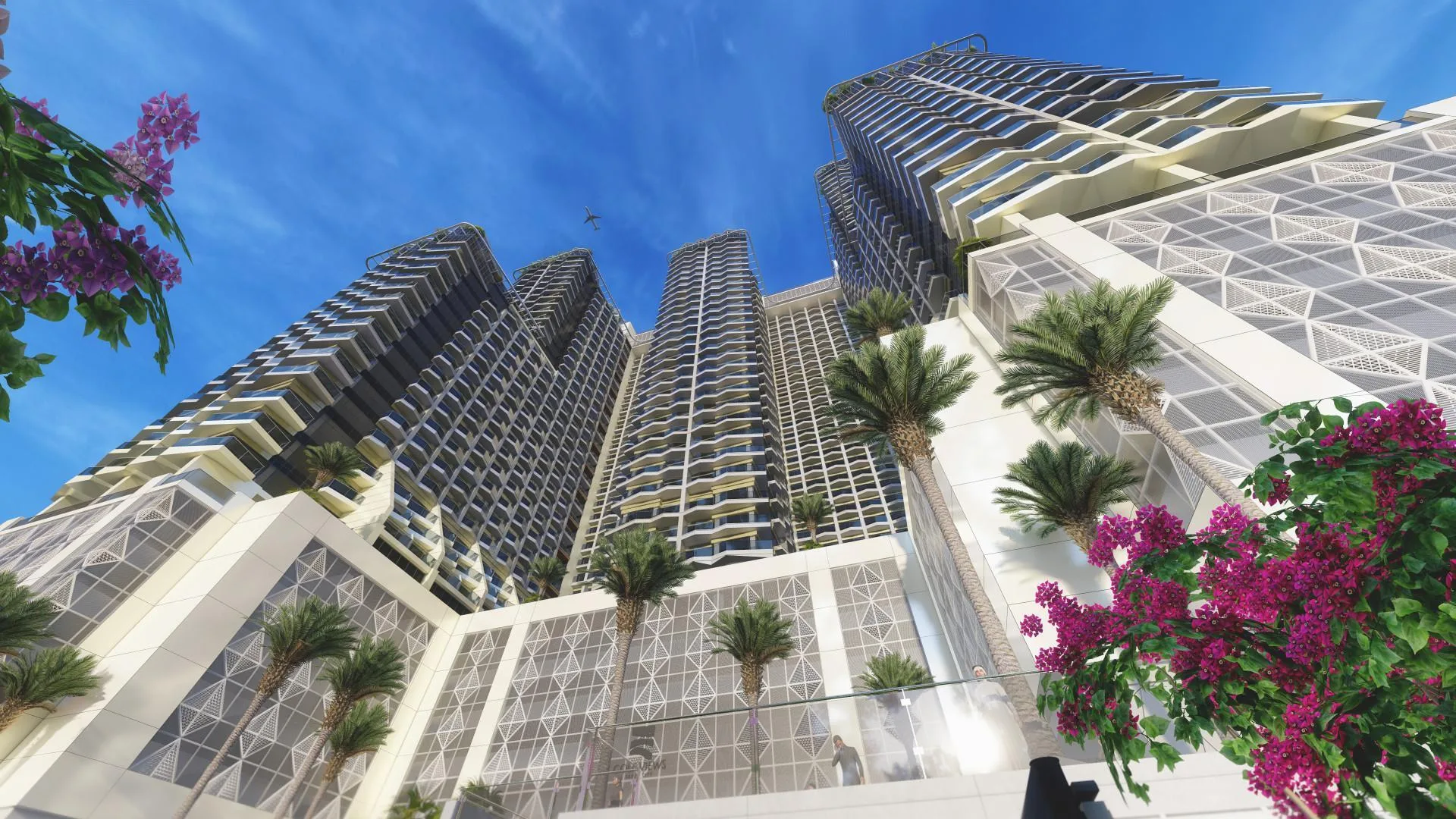 Башни Golf Views Seven City снизу: подиум, пальмы и бугенвиллея