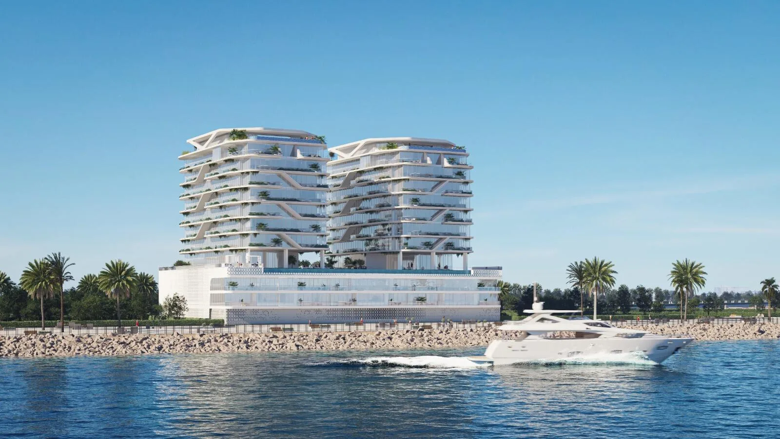 Две башни Hatimi Residences на берегу, перед ними яхта