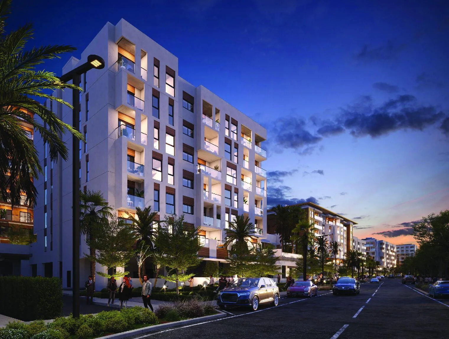 Hillside Residences вечером: подсвеченные окна и улица с пальмами