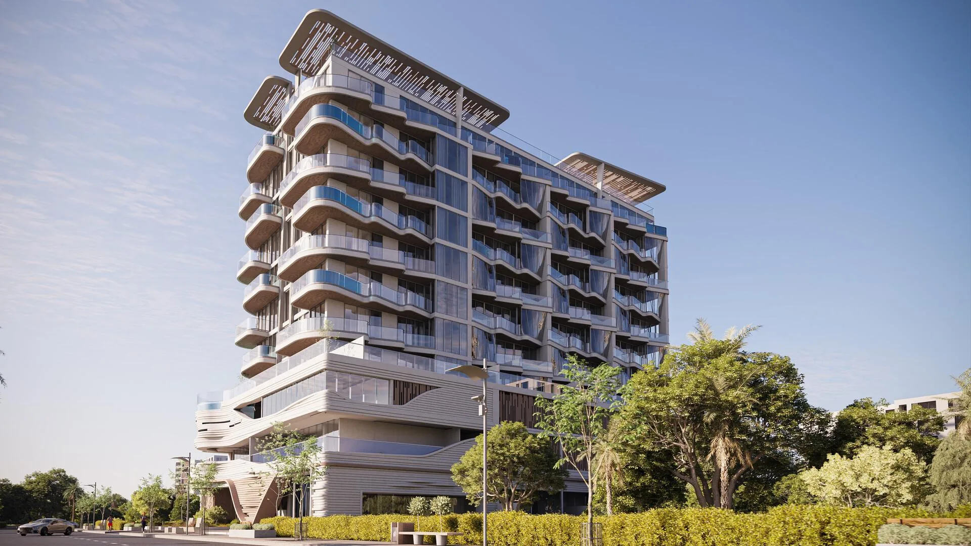 Дом Iluka Residences днём: светлый фасад с изогнутыми балконами