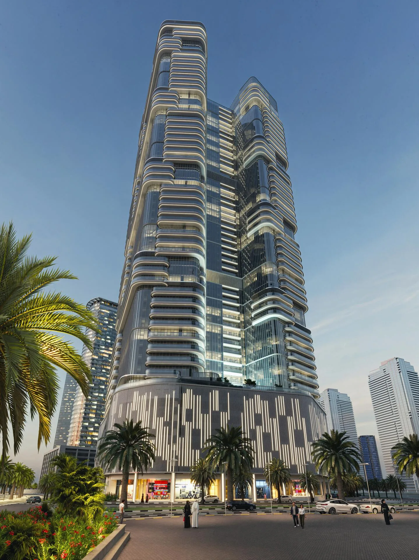 Joud Tower с улицы вечером: подсвеченный фасад и пальмы