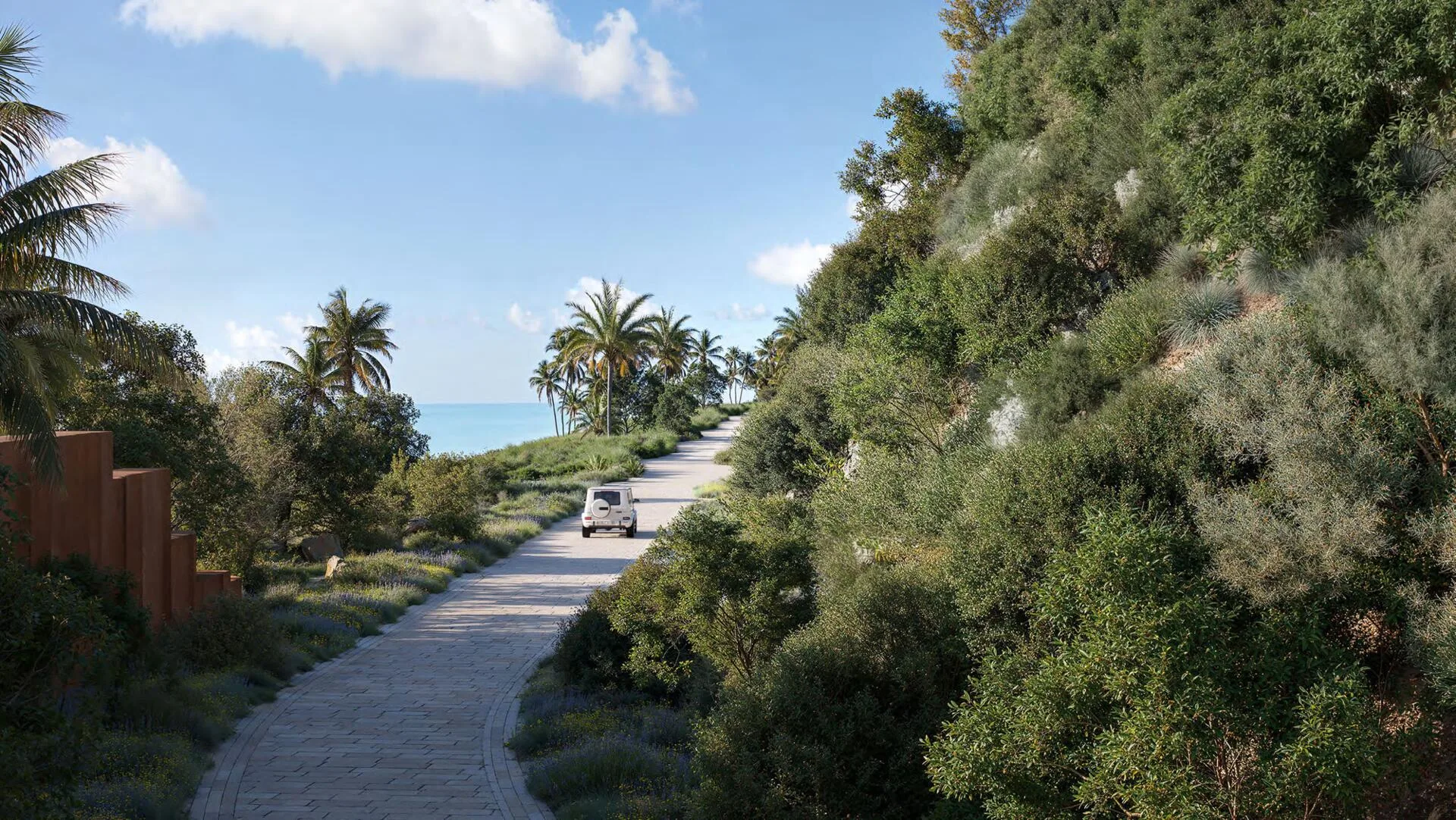 Дорога к Jumeirah Asora Bay вдоль зелёного склона к морю