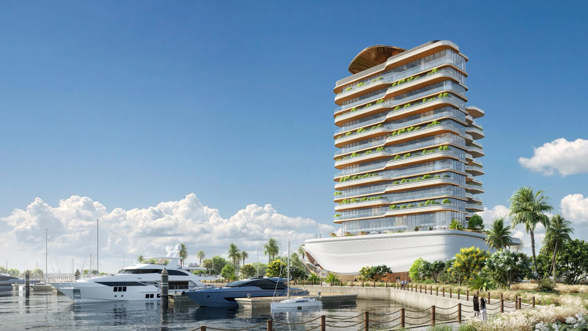 LIV Oceanside by day: a tower with wave-like terraces above a yacht berth