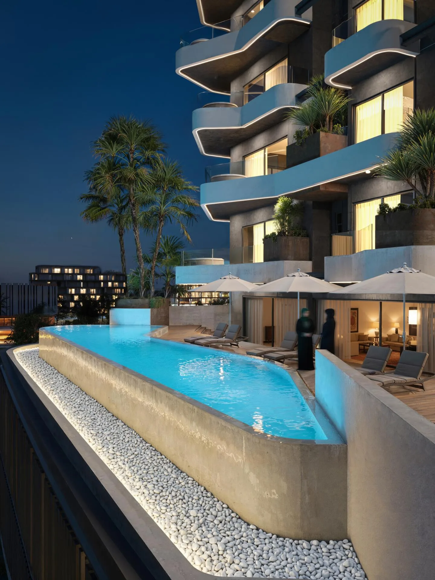 Бассейн Marea Residences вечером с подсветкой