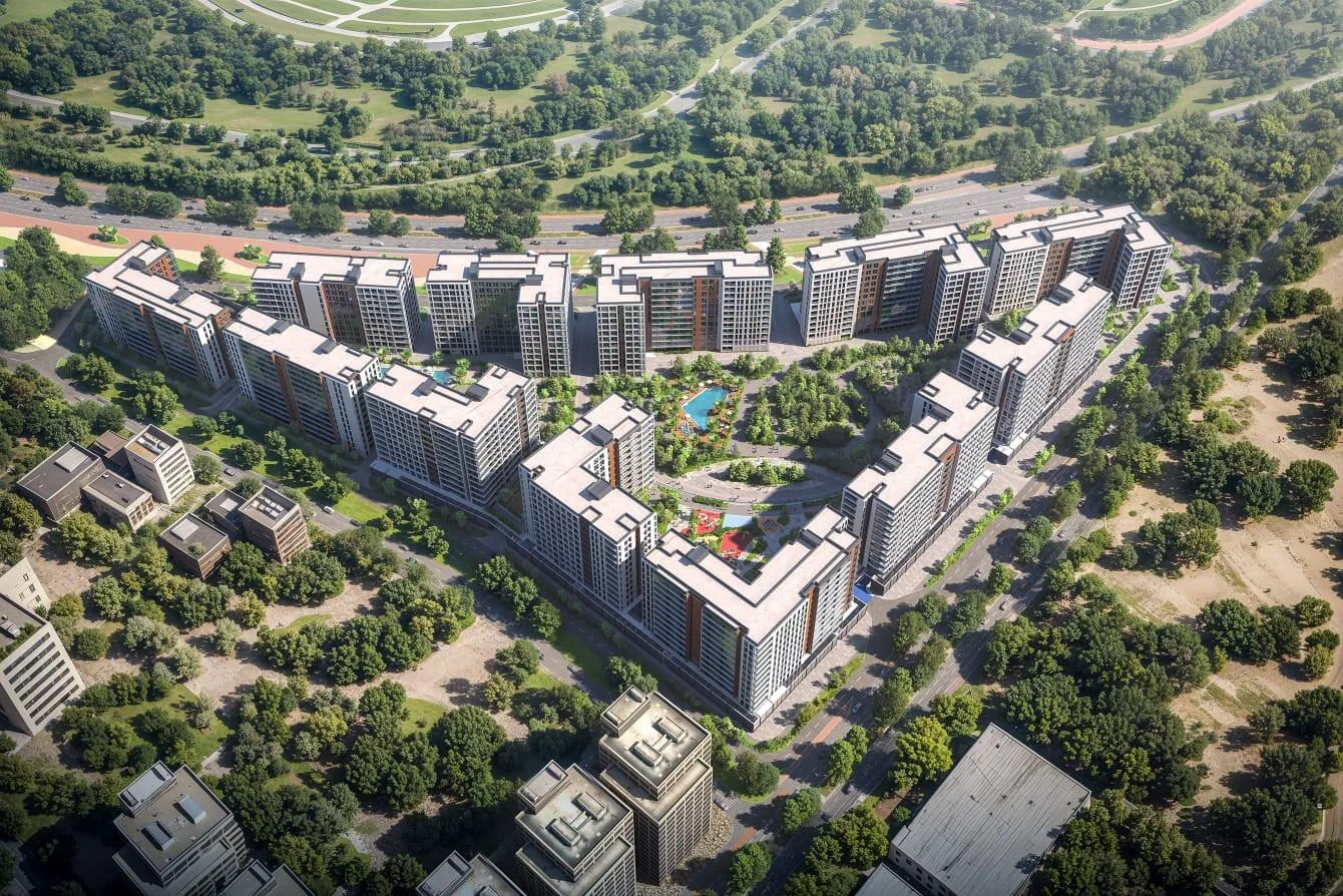 Квартал Olfah сверху: корпуса у широкой дороги и зелень вокруг