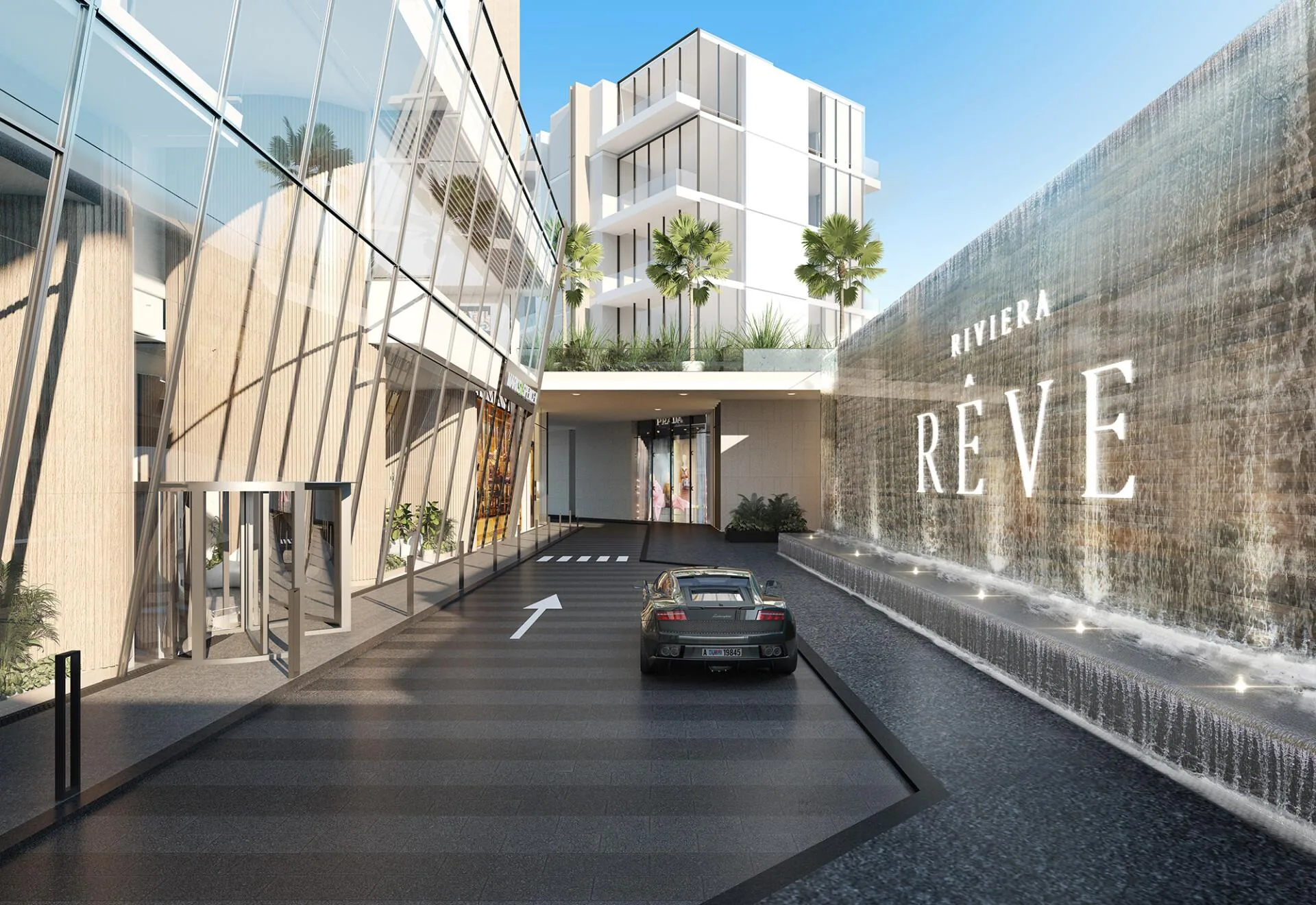 Въезд к башням Riviera Rêve вдоль стены с водопадом и надписью с именем дома