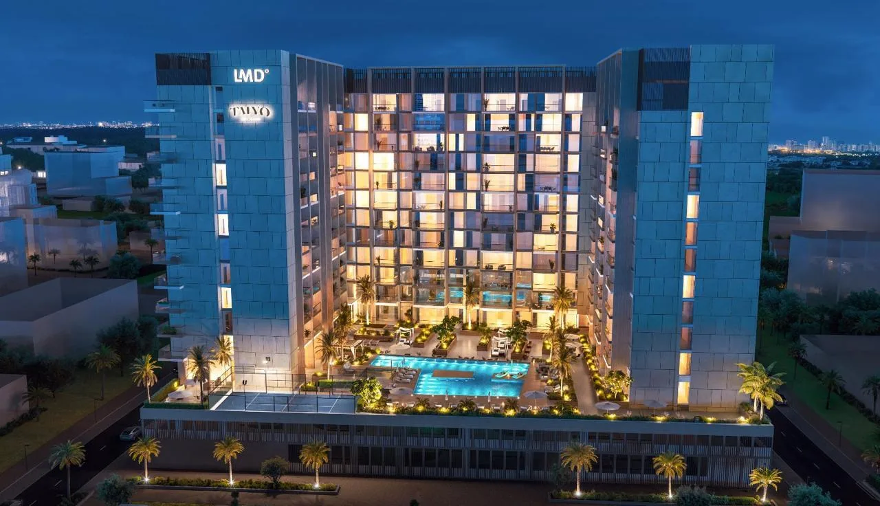 Taiyo Residences вечером с высоты, вокруг огни Wasl Gate