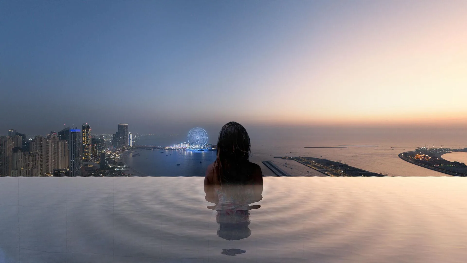 Бассейн с краем над городом и видом на Palm Jumeirah на закате