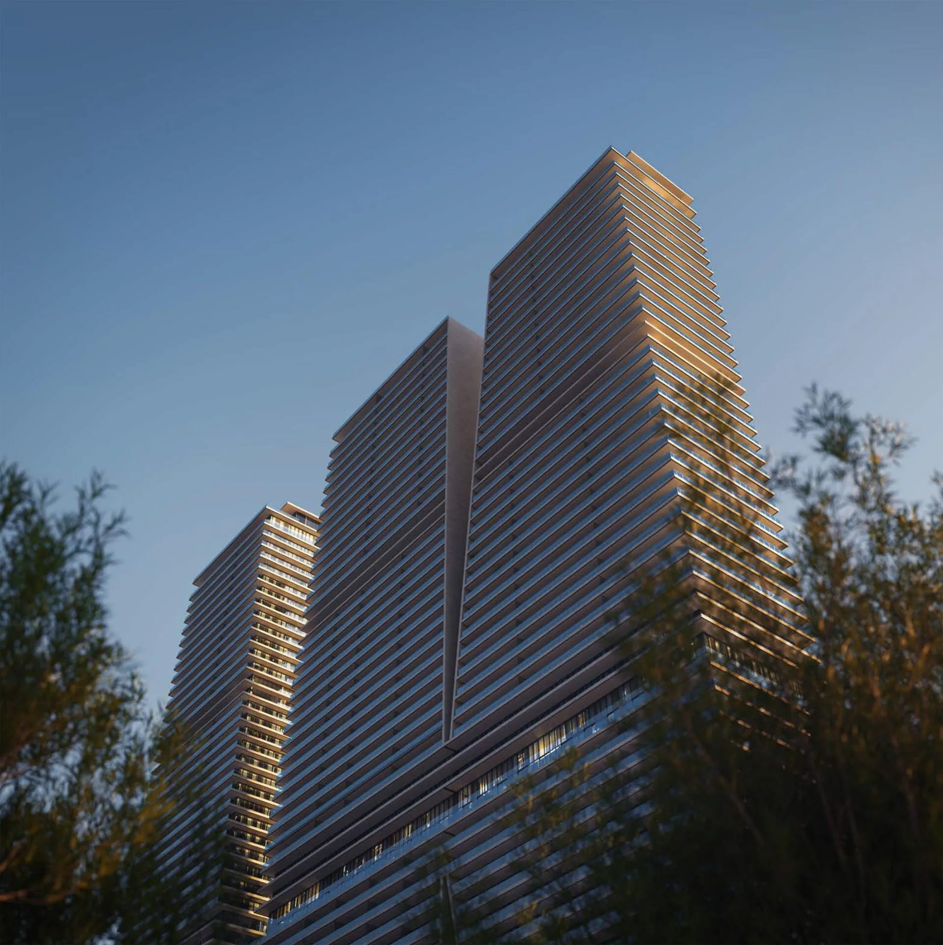 Фасады башен W Residences в вечернем свете за деревьями
